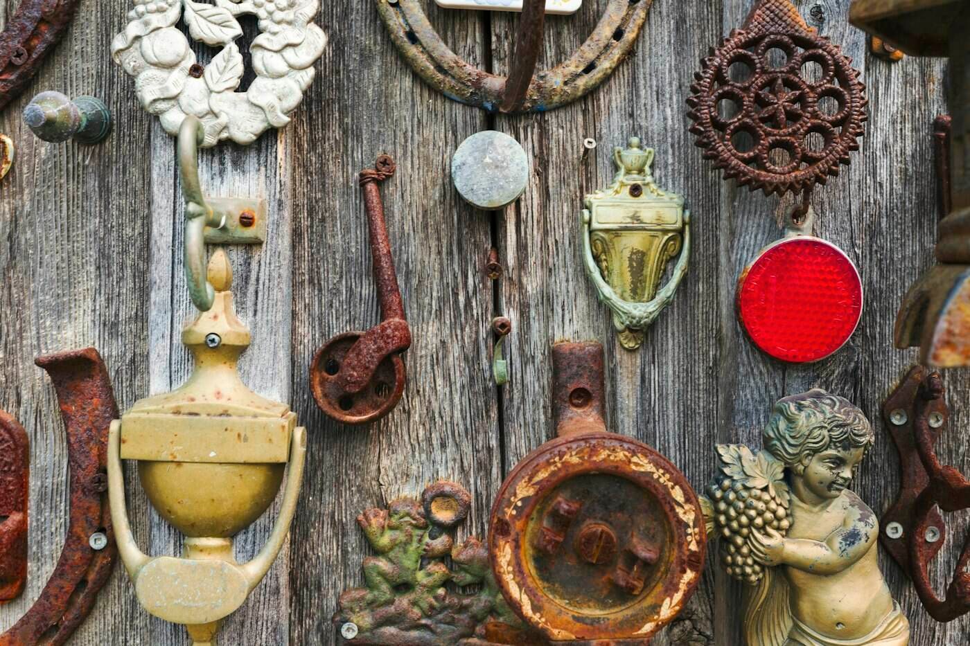 Weathered door decorated with reclaimed vintage hardware
